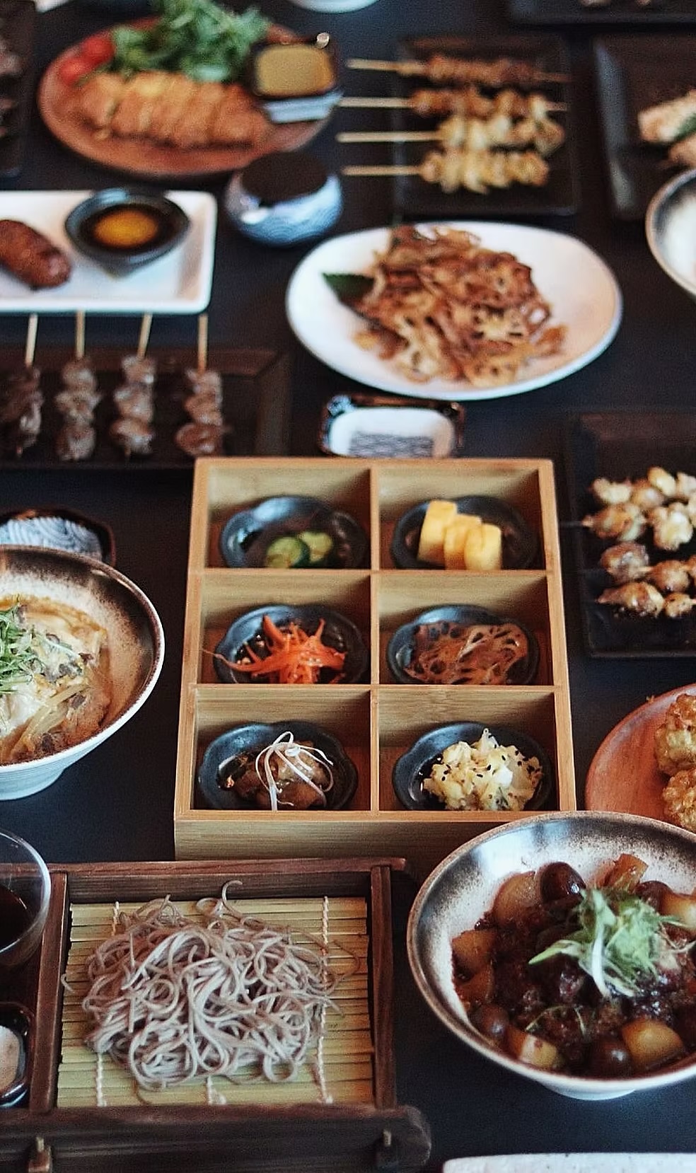 Izakaya feast of skewers, soba and a partitioned box of small sides
