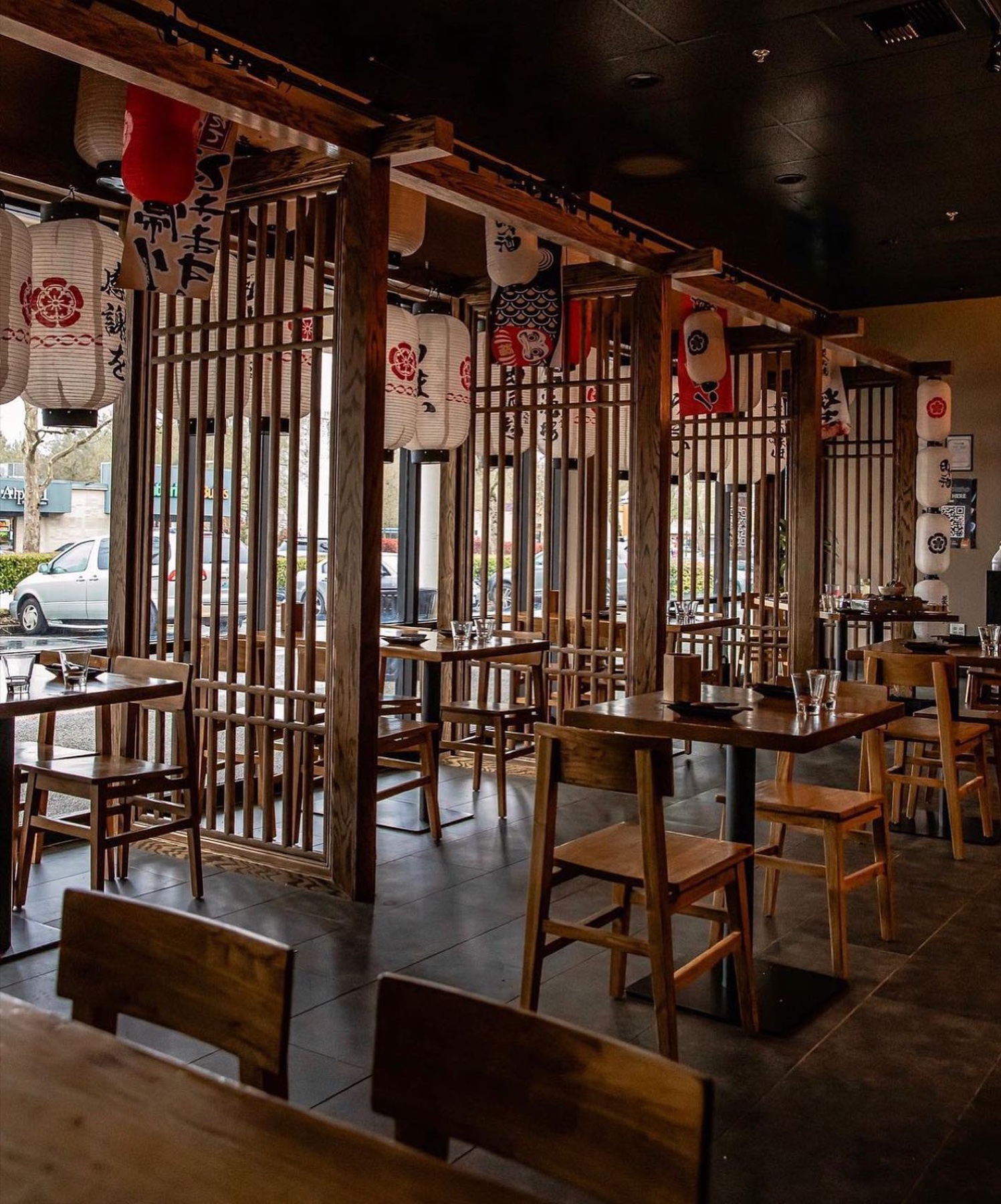 Redmond dining room with lanterns, shoji screens and wooden tables by the windows